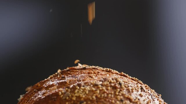 Bread multigrain loaf held in hands, whole wheat seeded crust with millet and seeds, close-up macro shot