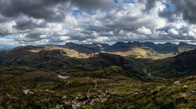 Panoramic Dramatic Mountain Landscape with Rolling Green Hills and Stormy Clouds over a Highland Valley