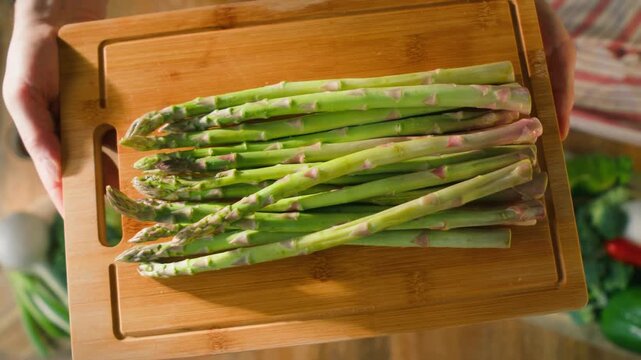 Fresh green asparagus on kitchen with broccoli and green pepper, vegan healthy food. Bunch of green asparagus close-up
