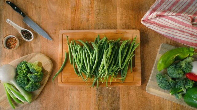 Fresh green beans and vegetables on a wooden table, spanish extra fine beans, chinese long bean. 
