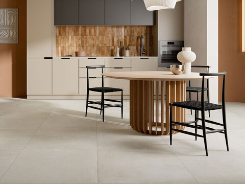 Modern dining room and kitchen interior with round wooden table and tiles