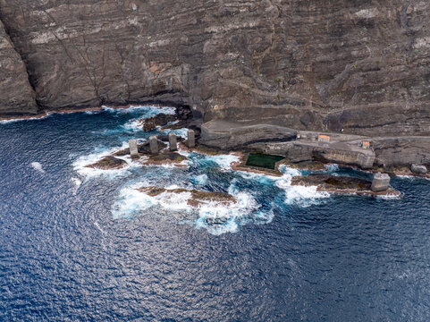 Aerial view of the rugged volcanic coastline and natural swimming pools of La Palma, Canary Islands, Spain.