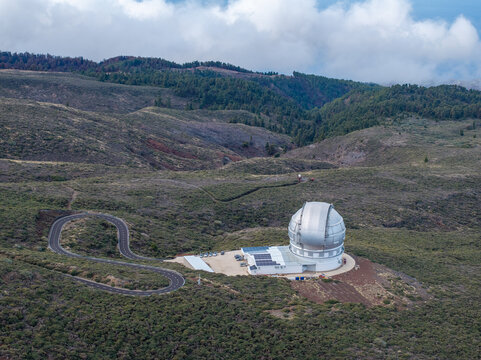 Aerial view of the Roque de los Muchachos Observatory dome set within the volcanic landscape of the Canary Islands, Spain.
