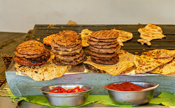 Baked burgers and other meat on metal grill sold on agricultural fair