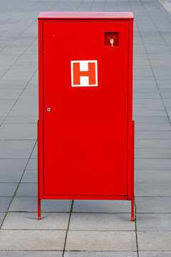 Red single door hydrant cabinet equipped with hoses and nozzles ready for emergency fire prevention