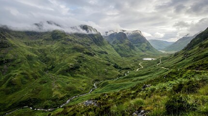 Fototapeta premium Stunning Lush Green Mountain Valley with Winding River Under Dramatic Cloudy Sky in a Wilderness Landscape