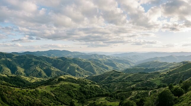 Beautiful Landscape of Vibrant Green Mountain Ridges and Valleys under a Dramatic Sky with Soft Clouds at Summer Day
