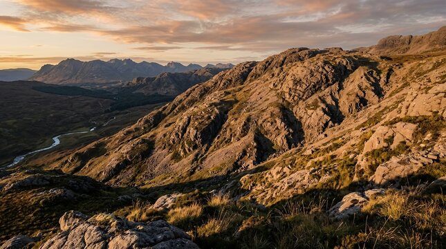 Dramatic Sunset over Rugged Rocky Mountains and Winding River Valley at Golden Hour in Wild Nature Landscape