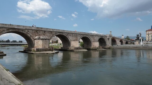 Skopje, North Macedonia - August 6, 2025: Stone bridge over Vardar river, Skopje. Urban construction and city infrastructure in Central Municipality in capital of Macedonia.