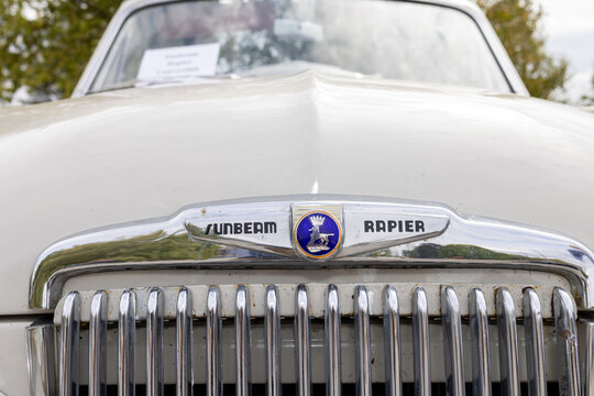 Harrogate, Yorkshire UK 17th August 2026: Close up of a classic Sunbeam Rapier showing the distinctive chrome front grille bonnet badge and period branding on the cream coloured British vintage car