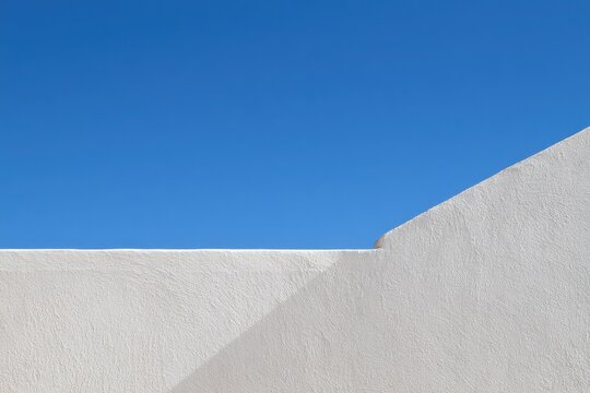 White textured wall with a crisp blue sky backdrop
