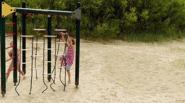 Two sisters play on a playground on the Baltic Sea in Jurmala, Latvia.