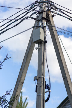 CCTV security camera and power box mounted on concrete utility pole
