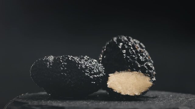Truffle mushroom, Fresh Black Truffles on Rustic Wooden Board, Gourmet Delicacy, Luxury Culinary Ingredient, Close Up Macro Video for Restaurant and Cafe Menu