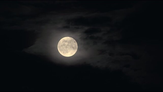Close-up of a glowing full moon in the dark night