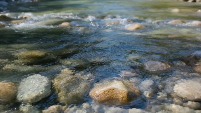 Clear Water Flowing Over Smooth Stones in a Mountain Stream