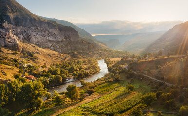 Vardzia cave monastery in Georgia at sunrise, Kura River in the valley © Игорь Кляхин