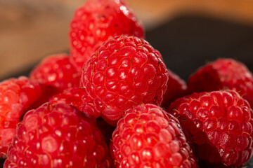 Fresh appetizing ripe raspberries in a detailed macro shot showing texture and vibrant red color © Vlad Ispas
