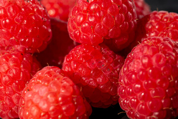 Fresh appetizing ripe raspberries in a detailed macro shot showing texture and vibrant red color © Vlad Ispas