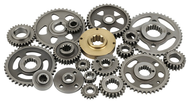Assortment of various metal gears and sprockets on a white
