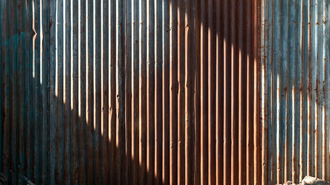 Rusted Corrugated Metal Wall Texture with Sunlight and Shadow