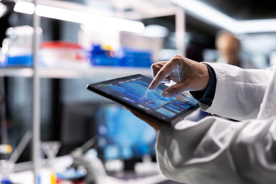 Close up of a tablet used to analyze chemical data during lab work, supporting medical discovery with bioscience and molecular research tools.