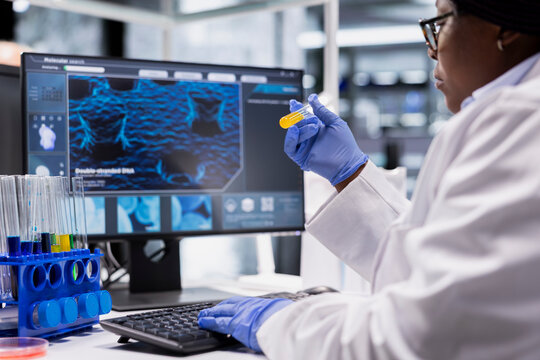 Researcher uses flasks and laboratory tools for a bioscience experiment, performing molecular analysis and advanced testing for biotechnology research in a biolab and medical research.