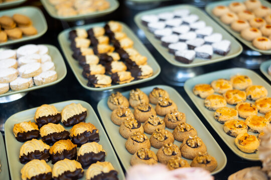 Delicious shortbread cookies with toppings on display in the store. Buying biscuits and certificates in the supermarket