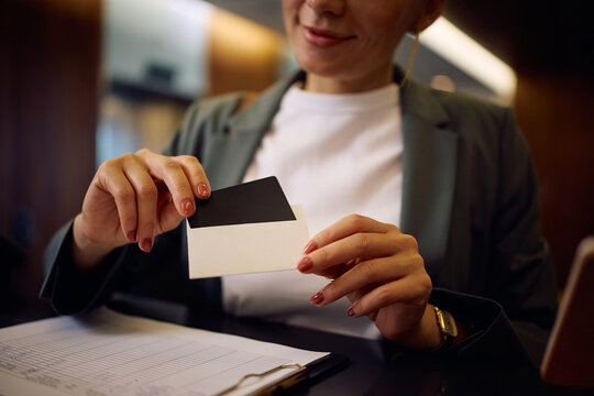 Close up of woman receiving membership card while checking in at spa reception