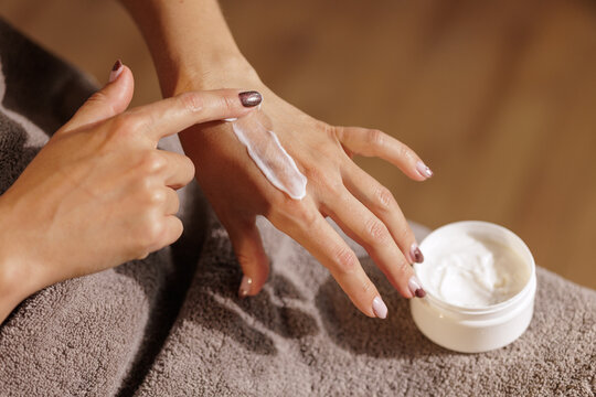 Female Hands Applying Moisturizing Hand Cream On Dry Skin