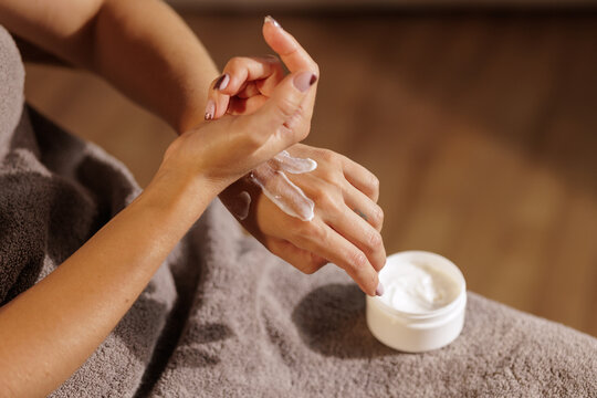 Woman Applying Moisturizing Hand Cream for Dry Winter Skin Care