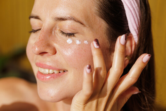 Woman Applying Eye Cream During Daily Facial Skincare Routine