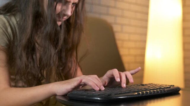 Frustrated stressed woman collapsing on computer keyboard. Overwhelmed young woman frantically typing on a computer keyboard and then collapsing from exhaustion and stress