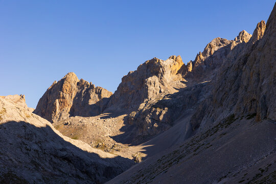Rocky landscape in natural mountainous area on border of Cantabria with Castile and Leon, northern Spain. Rocky landslides and mountain peaks, illuminated by bright midday sun, wildlife