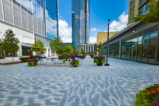 Spacious Reston plaza features patterned paving, outdoor furniture, and modern architecture.