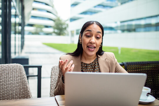 Businesswoman having video call on laptop at modern office terrace