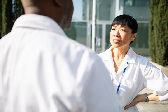 Healthcare professionals discussing patient care outside hospital