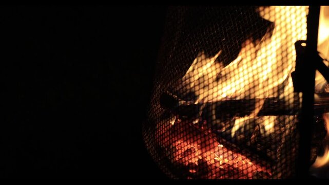 A bonfire burning red in the pitch-black night