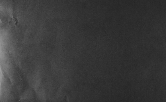 New blank black paper sheet, folded and wrinkled background and texture, design element