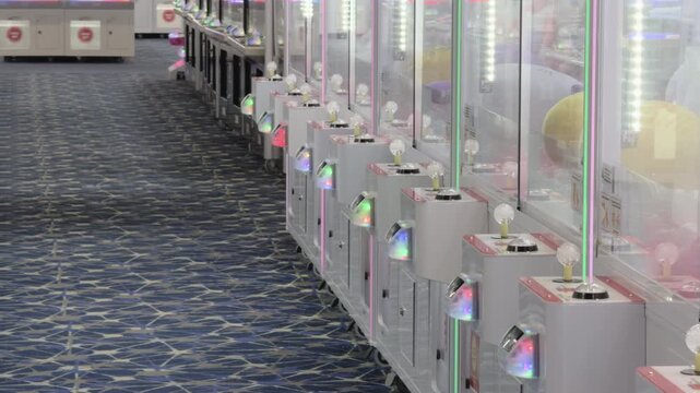 Rows of arcade claw games at arcade 4k