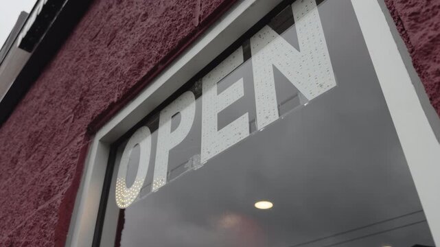 Flashing open sign outside of restaurant window 4k
