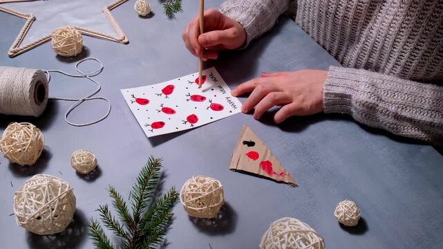 Painting Reindeer fingerprints Gift Christmas idea. Do it yourself instruction postcard eco-friendly decoration. Making handmade presents children's diy projects. Holiday family time. Creative