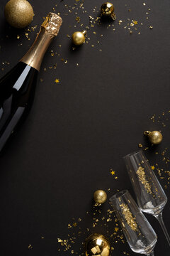 Happy New Year 2027 celebration with champagne, gold ornaments and vertical elegant winter holiday styling