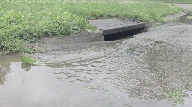 Water going down curb gutter after storm 4k
