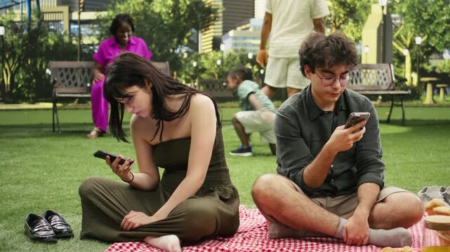 Couple ignoring each other while doomscrolling on smartphones