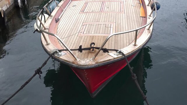 A boat is tied up at a marina during the day