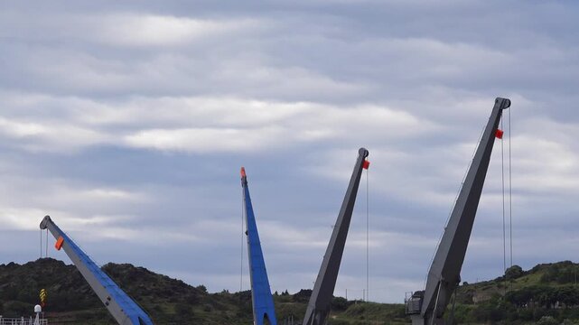 Cranes at the dock site under clouds