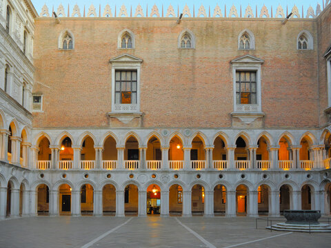 Interior courtyard of the Doge's Palace in Venice, Italy with arched colonnade and brick facade