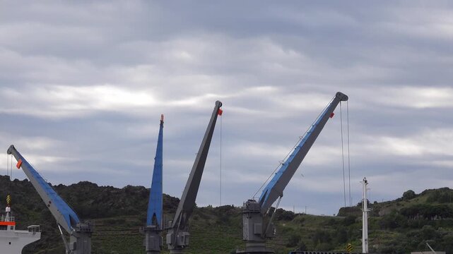 Cranes operate at a dock to load and unload cargo