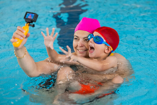 Mother son swimming pool selfie using action camera